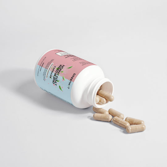 A bottle of GreenHat Epimedium Blend libido supplements spilled open with capsules scattered on a plain white background.