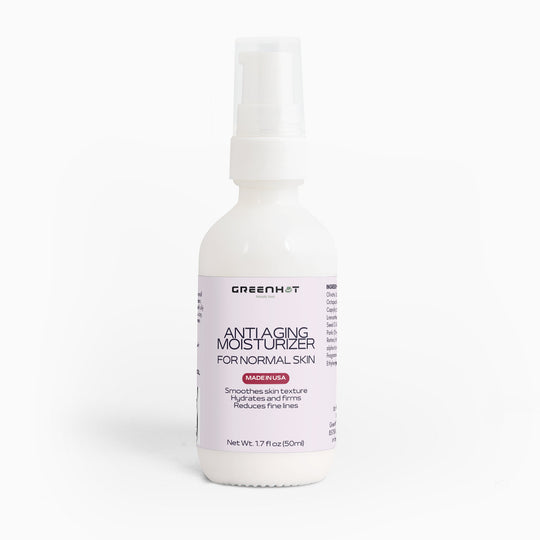 A white bottle labeled "GreenHat Anti Aging Moisturizer for Normal Skin - Double Pack" with 50ml content. The label states it smooths skin texture, hydrates, firms, boosts collagen production, and reduces fine lines.