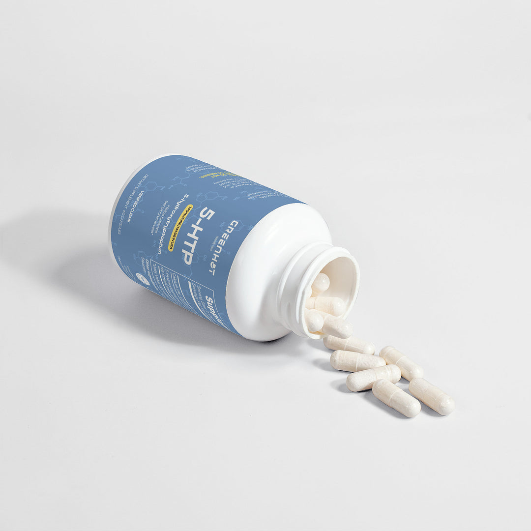 A blue-labeled bottle of 5-HTP - Double Pack supplements by GreenHat, renowned as a serotonin enhancer, lies on its side with white capsules spilling out onto a flat surface.