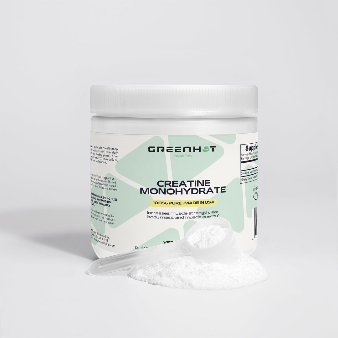 A container of GreenHat Creatine Monohydrate - Enhance Strength & Performance powder with a white plastic scoop and some powder spilled in front of it. The label mentions it's 100% pure, made in the USA, and enhances muscle protein synthesis to boost athletic performance.