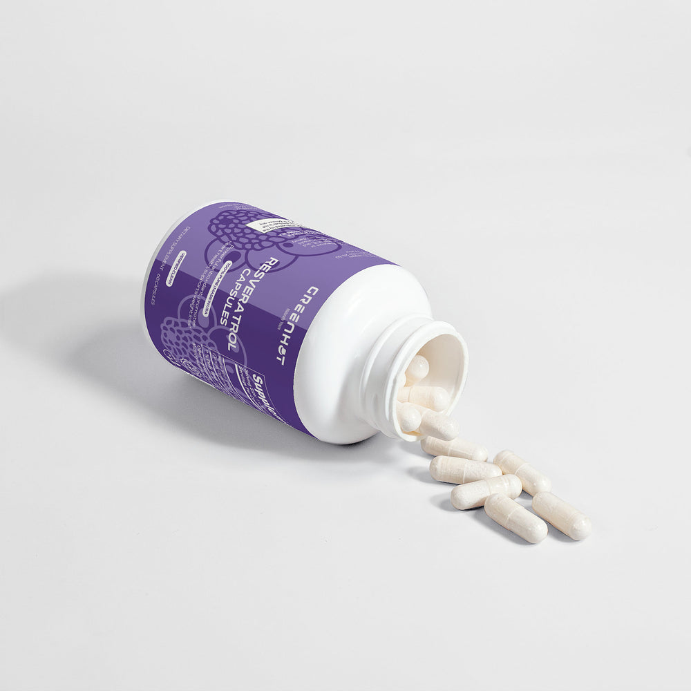 A white and purple pill bottle labeled "Resveratrol 50% 600mg - Antioxidant Powerhouse" by GreenHat lies on its side, with several white capsules, rich in Resveratrol's antioxidant health benefits, spilling out onto a white surface.
