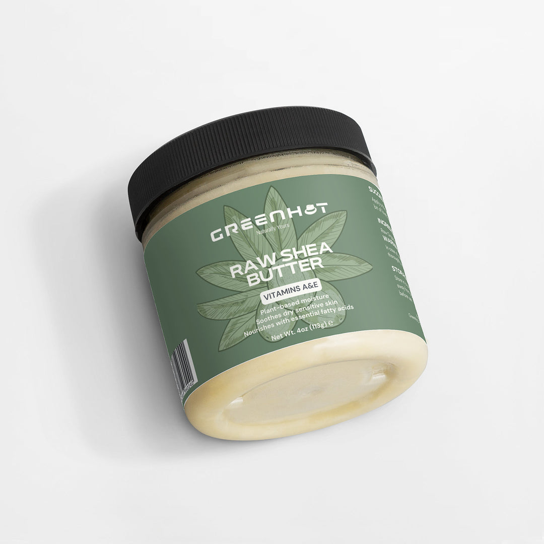 A jar of GreenHat Raw Shea Butter with a label detailing ingredients and vitamins A, E, and F. The jar has a black lid and contains 4 oz (113 grams) of plant-based moisturizer, offering unrefined goodness.