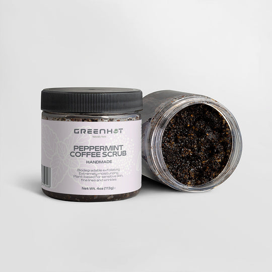 Two jars of GreenHat Peppermint Coffee Scrub against a plain background. One jar is upright, labeled "Handmade, 4oz," while the other is open and tipped, revealing the antioxidant-rich coffee scrub inside. Perfect for effective exfoliation and revitalizing your skin.