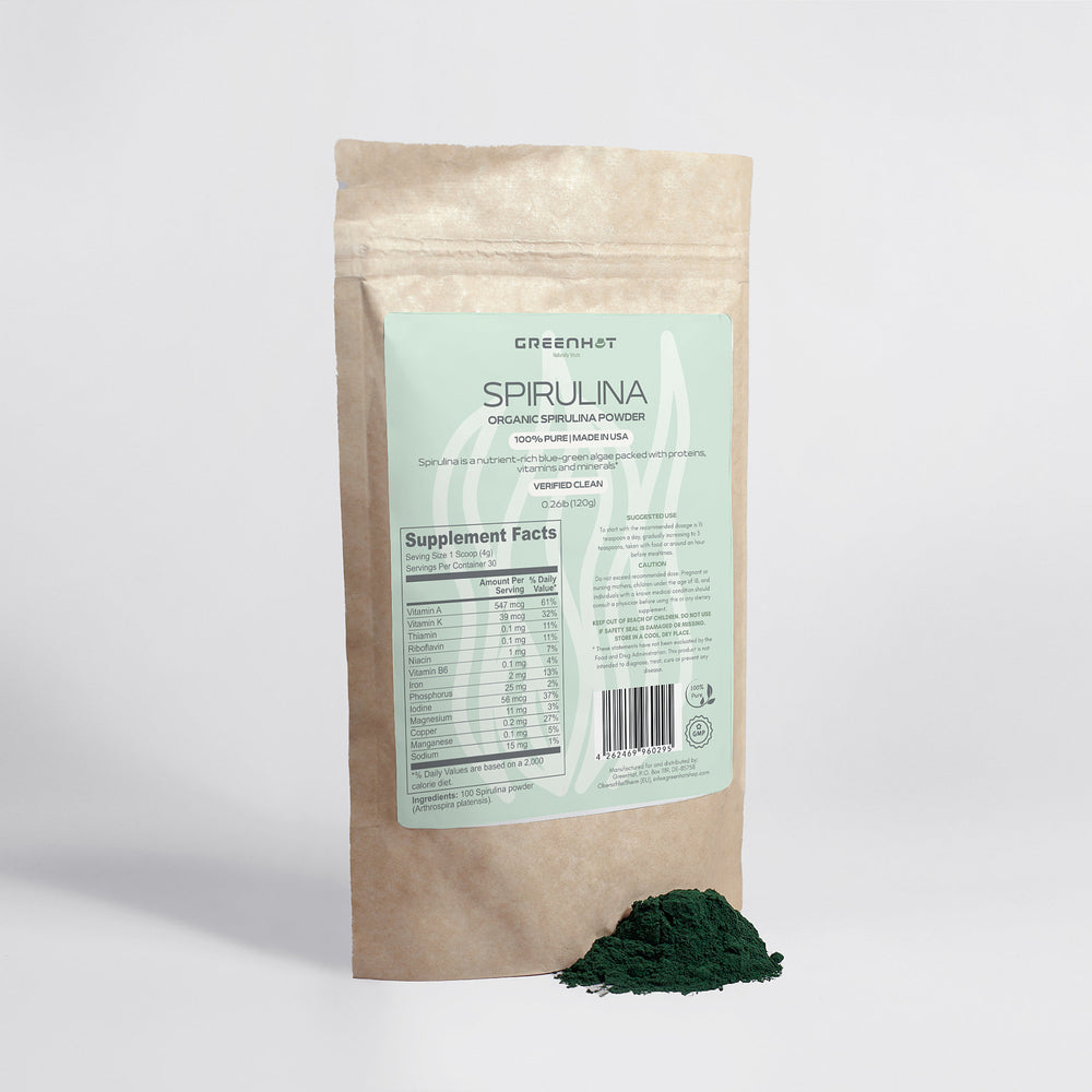 A brown resealable package labeled "GreenHat Organic Spirulina Powder - Ocean's Best" with nutritional information shown on the front promotes its dense nutrient content. A small pile of green powder, known for being high in protein, is placed beside the package.