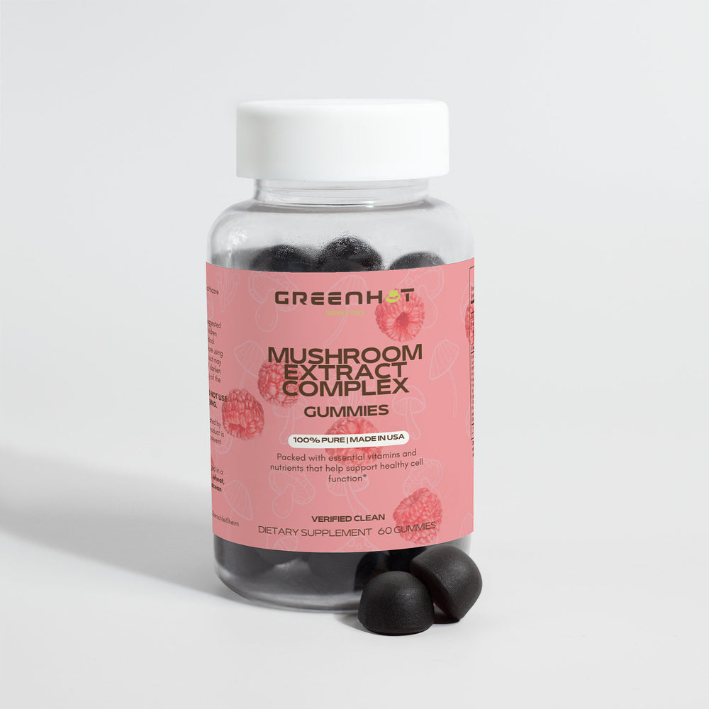 A bottle of GreenHat Mushroom Extract Complex Gummies with a pink label, promising stress relief and immunity boost, sits beside two black gummies. The bottle contains 60 dietary supplement gummies.