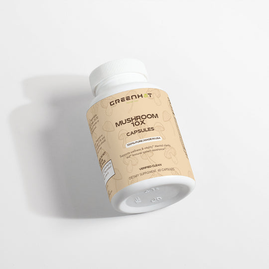 A white bottle with a beige label reading "Mushroom Complex 10 X - Natural Power" by GreenHat, containing 60 adaptogenic mushroom supplements with a net weight of 43g. The label also mentions "100% Pure Framed Mush.