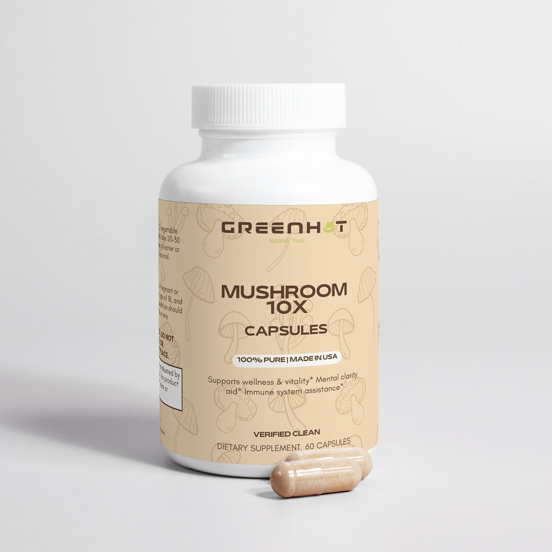 A white bottle labeled "GreenHat Mushroom Complex 10 X - Natural Power" with two beige capsules beside it. The label mentions wellness, vitality, mental clarity, and immune system assistance. Contains 60 medicinal mushroom capsules designed to support your health and well-being.