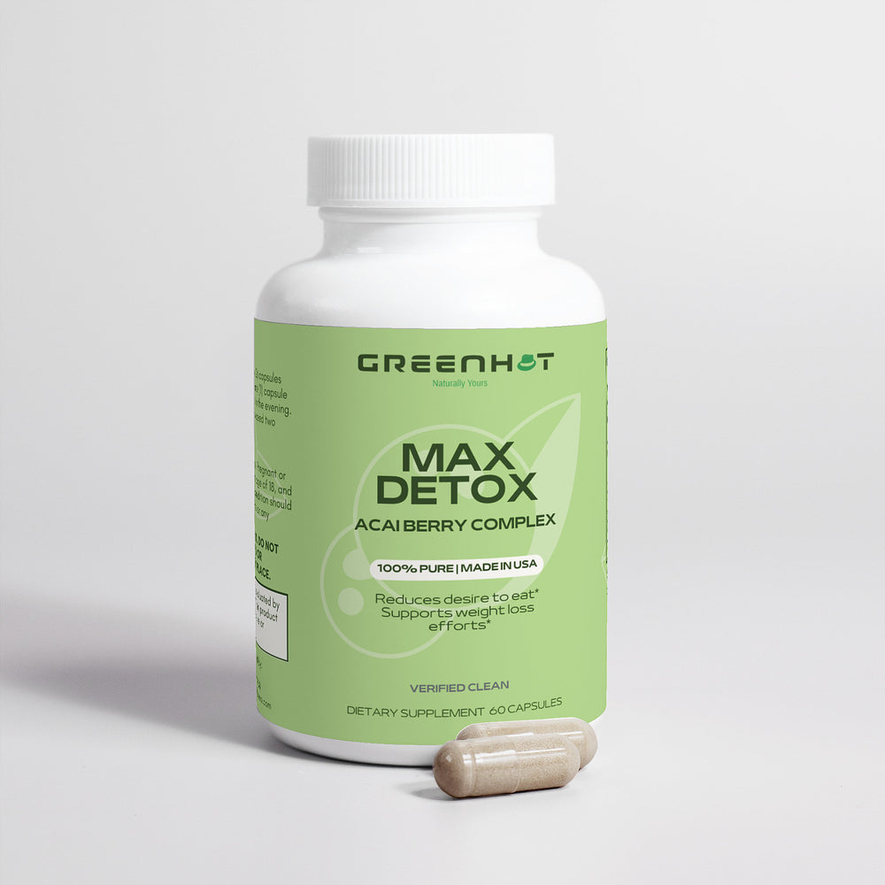 A white bottle labeled "GreenHat Max Detox (Acai detox) – Detoxifying Cleanse" with 60 capsules is placed beside two brown capsules. The label claims appetite reduction, weight loss support, and detoxification. Made in the USA, it's designed to help cleanse your body effectively.