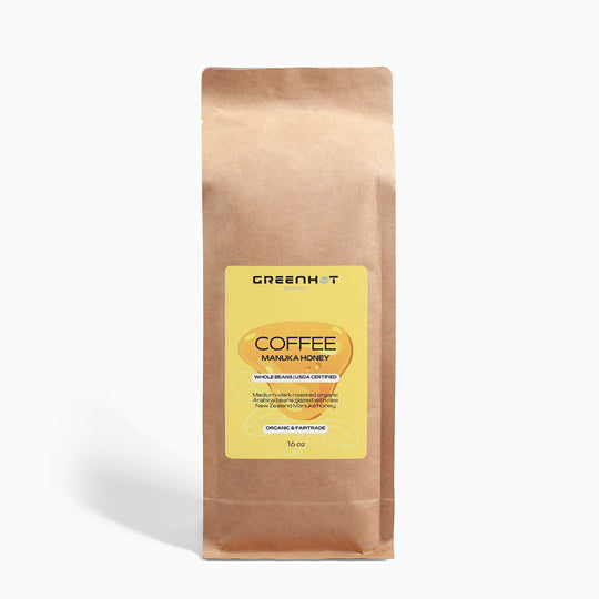 A brown paper bag labeled "Manuka Honey Coffee 16oz - Awaken Your Senses" with yellow branding, containing New Zealand Arabica beans, net weight 12 oz.