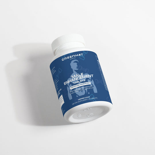 A bottle labeled "GreenHat Male Enhancement - Performance Booster" with a blue label, lying on a white surface. The label indicates dietary supplements, containing 60 male enhancement capsules designed to address libido issues and act as a performance booster.