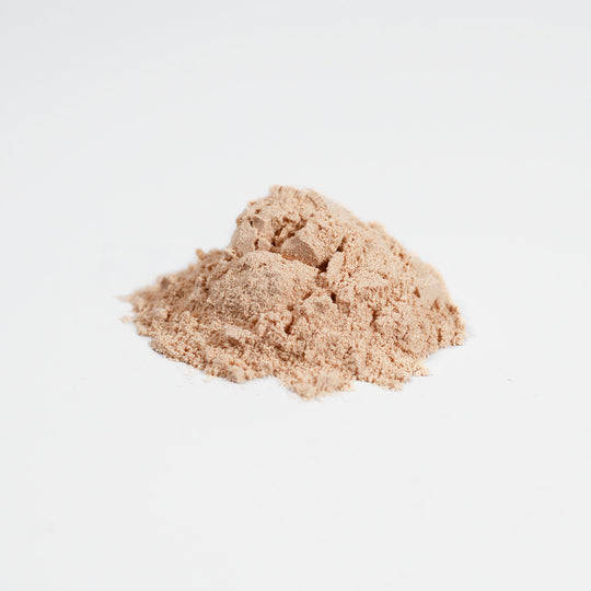 A small pile of GreenHat Fermented Mushroom Blend powder isolated on a white background.