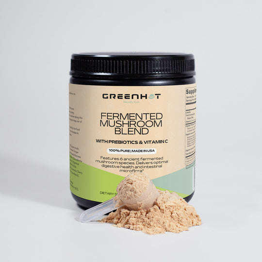 A jar of GreenHat Fermented Mushroom Blend supplement with a scoop of powder in front on a white background, designed to support holistic well-being.