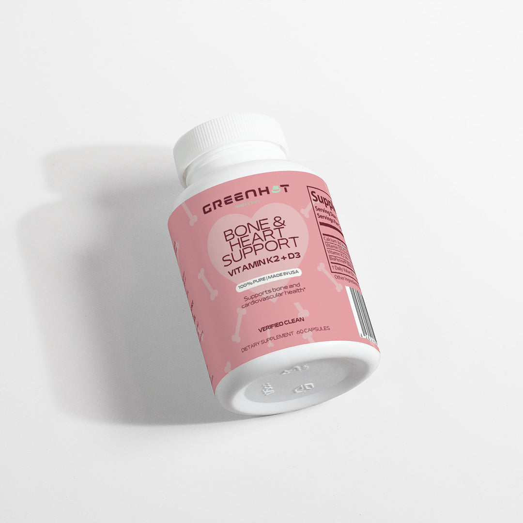 A bottle of GreenHat's Bone & Heart Support - Strengthen Your Foundation supplements with vitamin K2 and D3, lying on a white background.