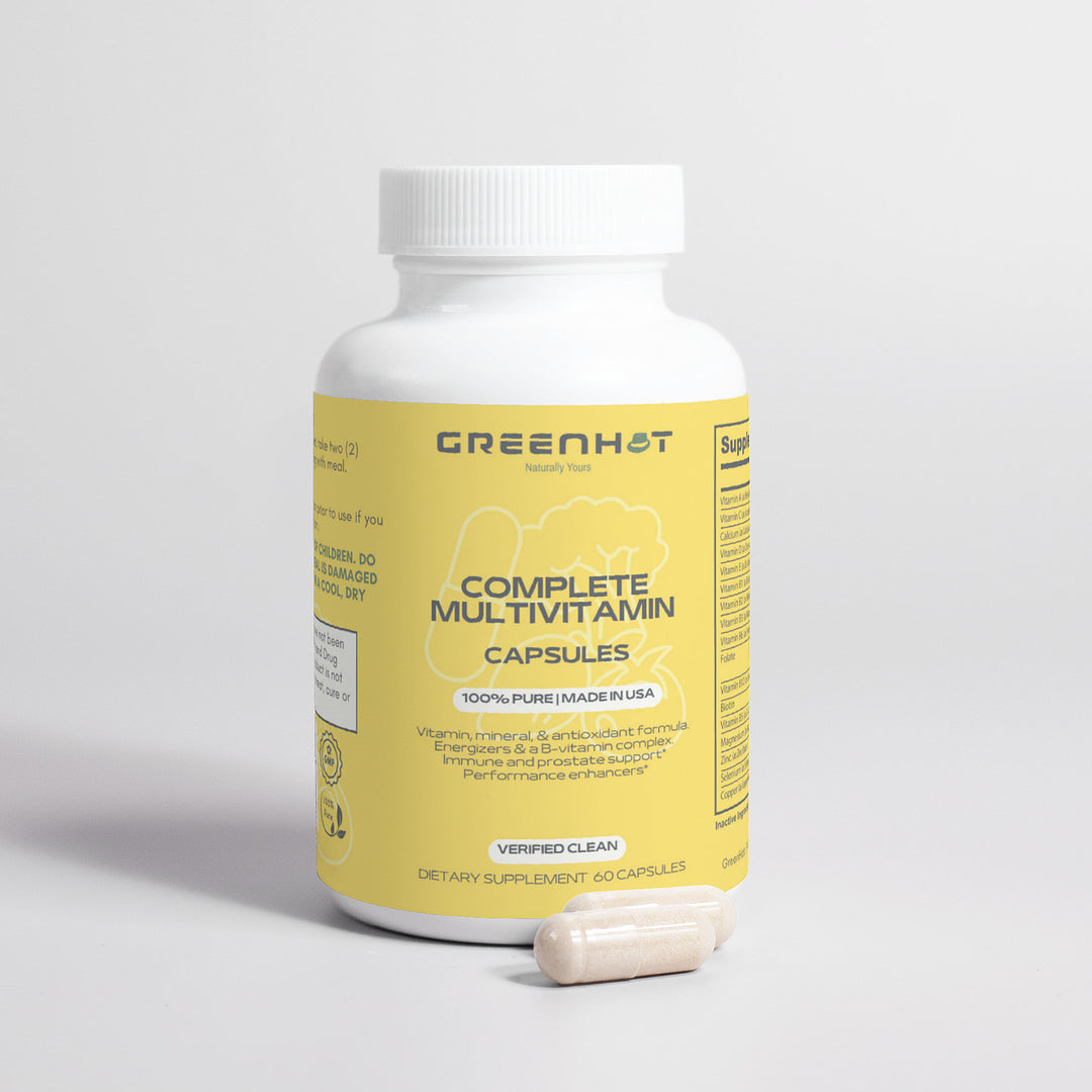 A bottle of GreenHat Complete Multivitamin capsules on a plain background with two immune-boosting herbs capsules in front of it.