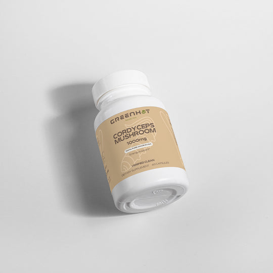 A white bottle labeled "GreenHat Cordyceps Mushroom - Enhanced Physical Performance" lies on its side against a light gray background, promising boosts in physical performance and cognitive function.