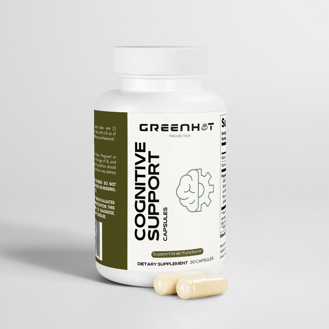 A white bottle labeled "GreenHat Cognitive Support," featuring a brain graphic, contains a cognitive enhancement supplement with natural ingredients. Two capsules are placed beside the bottle on a white surface, emphasizing mental clarity.