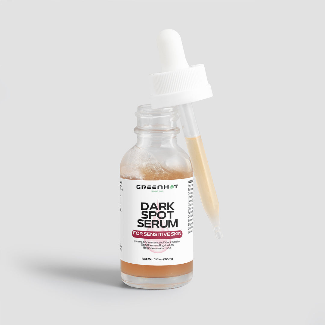 A bottle of GreenHat Dark Spot Serum for Sensitive Skin with a dropper leaning against it. The label highlights that this serum is formulated for sensitive skin and enriched with natural extracts. It contains 1 fl. oz. (30 ml) of product, promising gentle yet effective care for your complexion.