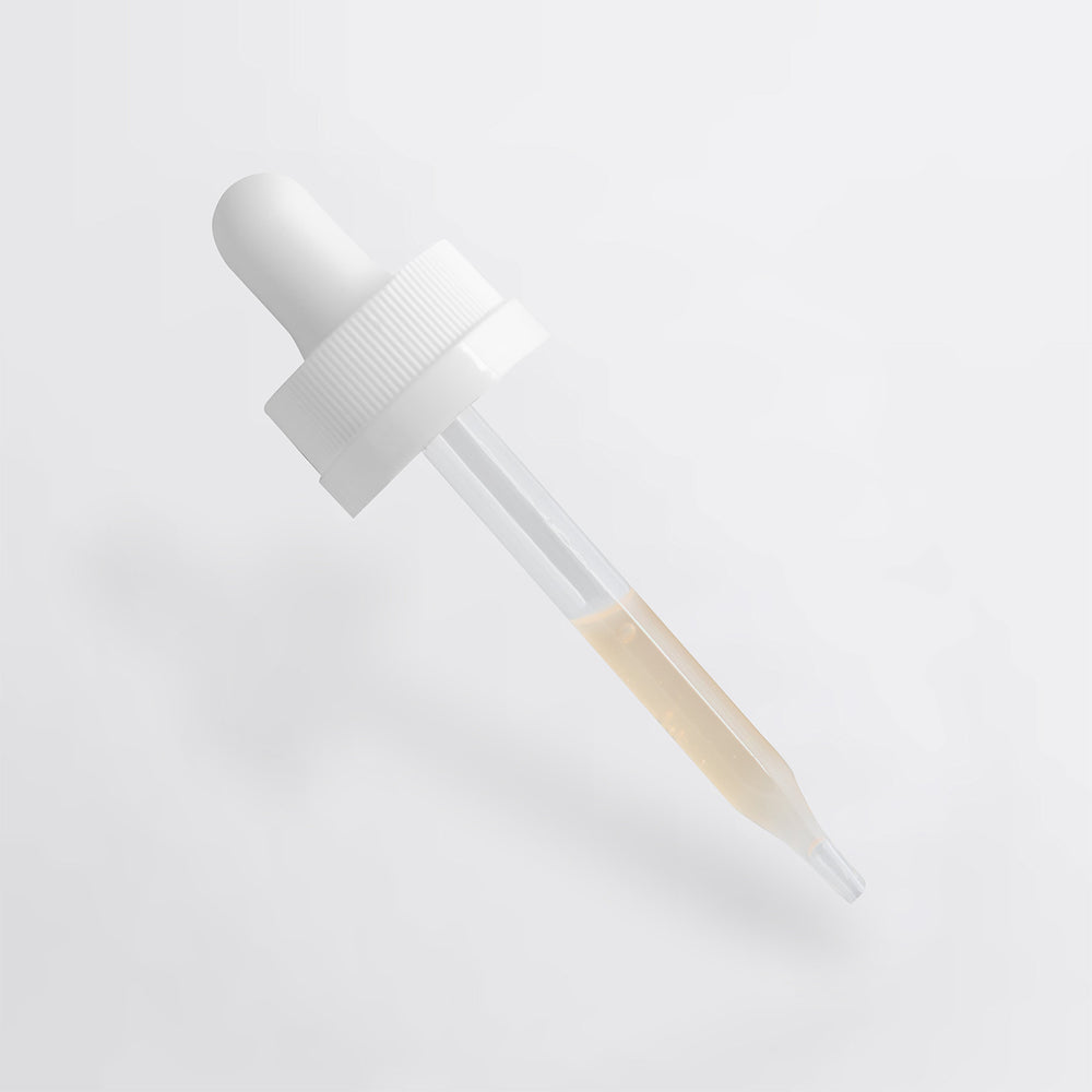A transparent dropper filled with Dark Spot Serum for Sensitive Skin by GreenHat, ideal for sensitive skin.