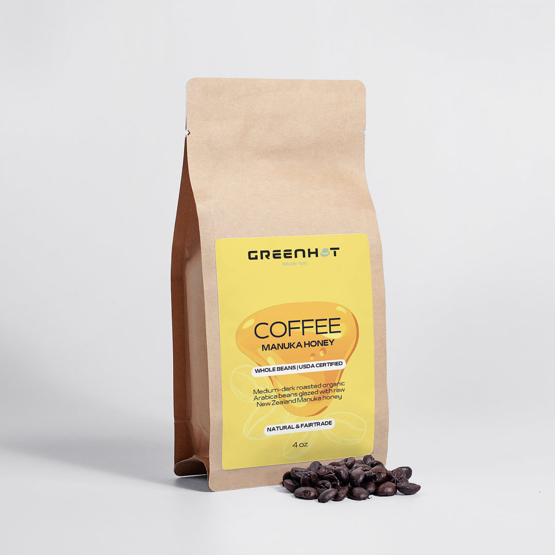 A brown paper bag labeled "GreenHat Manuka Honey Coffee 4oz - Awaken Your Senses" with Arabica beans next to it, placed on a white background.