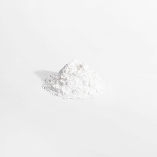 A small pile of GreenHat L-Glutamine Powder on a plain white background.