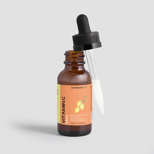 A bottle of GreenHat Vitamin C Serum - Hydration and Skin Tone Enhancement with a dropper, labeled "green+ vitamin c," against a plain gray background.