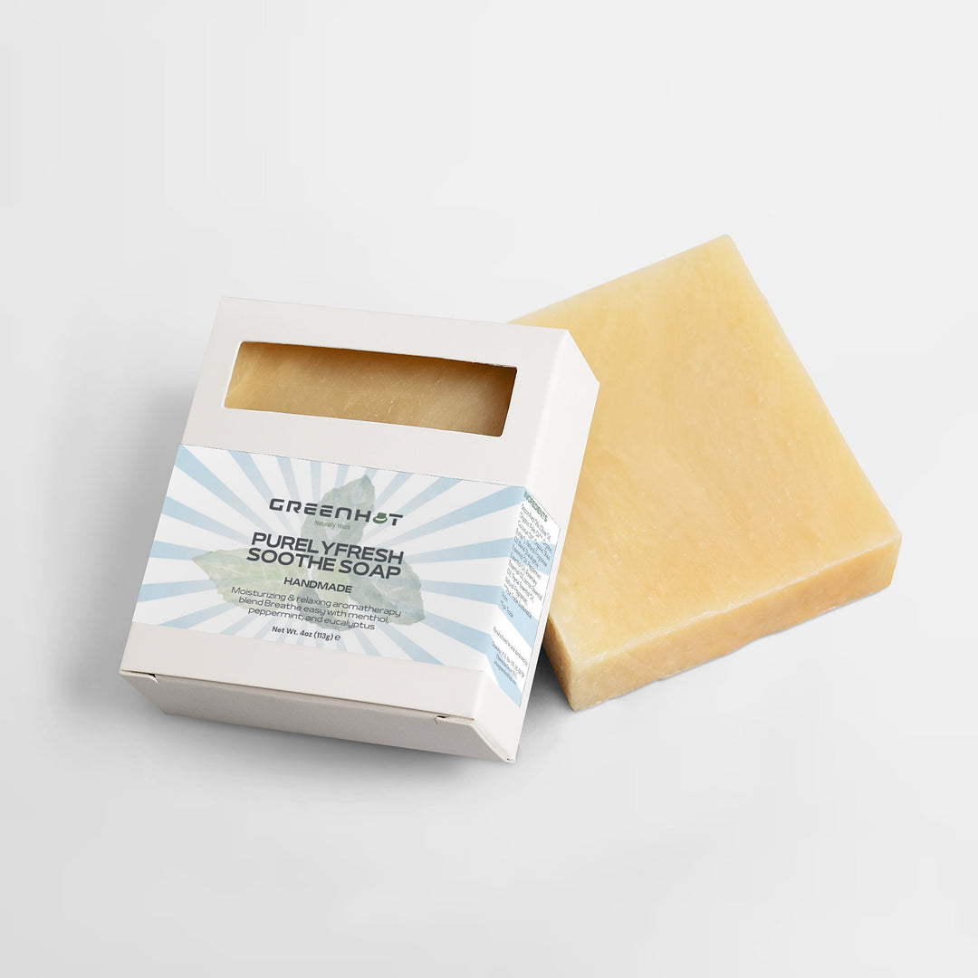 A bar of GreenHat's PurelyFresh Soothe Soap next to its open packaging on a white background.