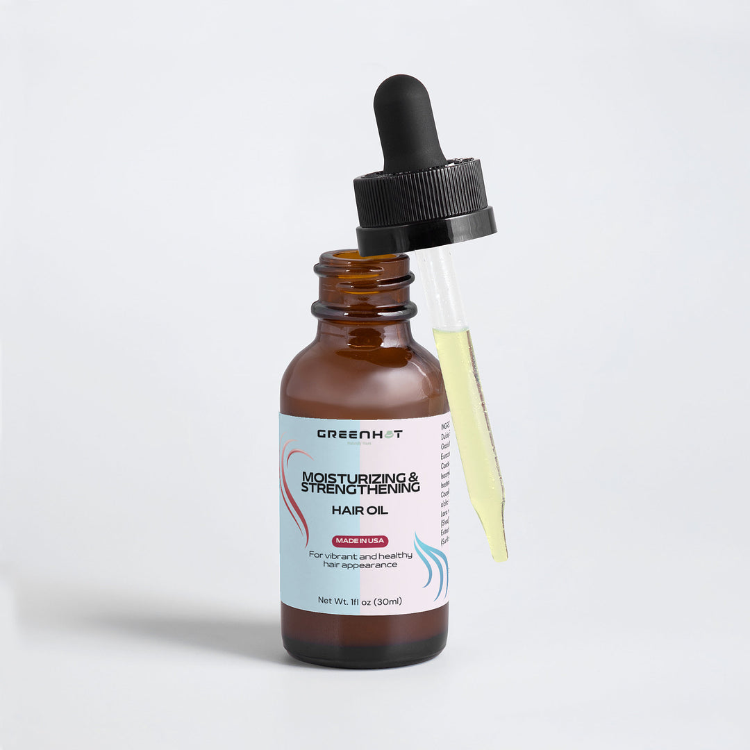 A brown glass bottle of GreenHat's Moisturizing and Strengthening Hair Oil with keratin and a black dropper, set against a white background.