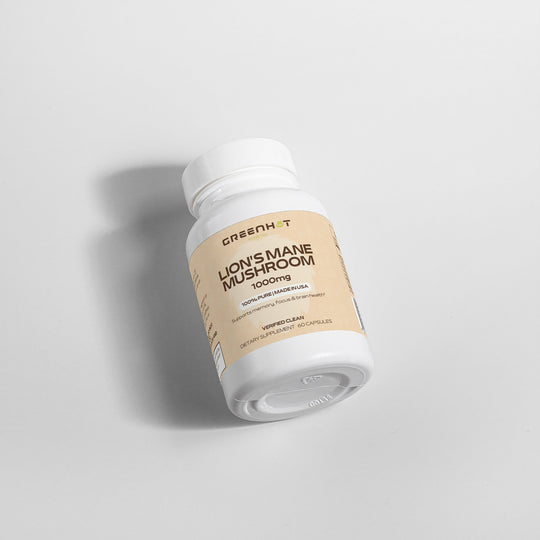 A bottle of GreenHat's Lion's Mane Mushroom - Cognitive Enhancement supplement, with 1000 mg dosage, lying sideways on a plain white background.